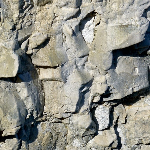 Natural texture of weathered chalk cliff rock