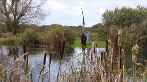 Pond with bulrushes and sculptures