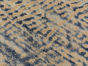 Patterns of black detritus on intertidal sand