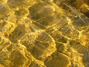 Natural patterns of reflected light on a stream