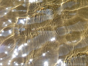 Reflected light on the surface of a stream with sparkles