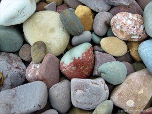 Large pebbles of different rock types on the beach