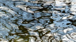 Macro shots of natural patterns of reflected light on fast-flowing water