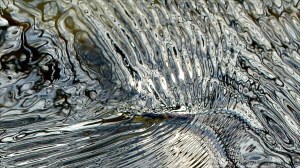 Intricate changing patterns of reflected light on fast flowing water