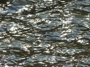Abstract patterns of light reflected on the surface of flowing water
