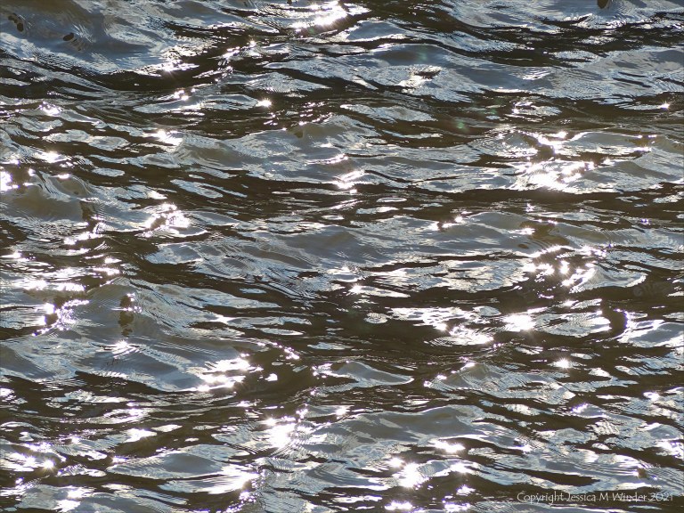 Abstract patterns of light reflected on the surface of flowing water