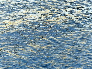 Reflected light on water in a deep flowing river