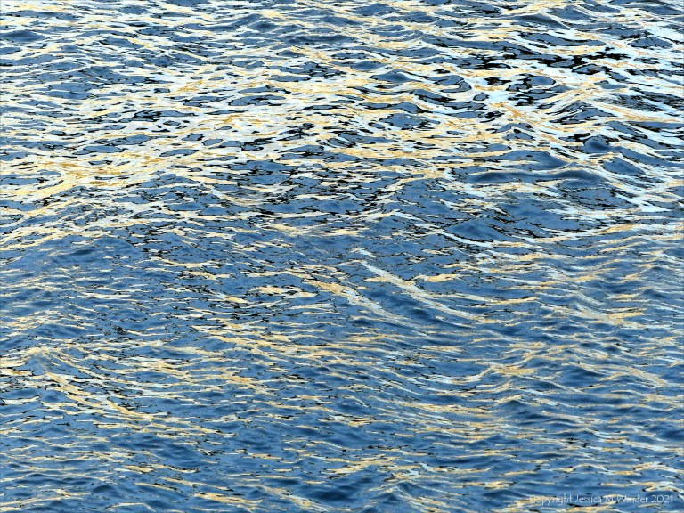 Reflected light on water in a deep flowing river