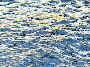Reflected light on water in a deep flowing river