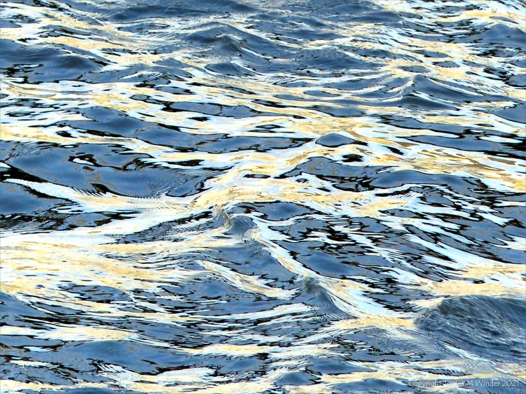 Reflected light on water in a deep flowing river