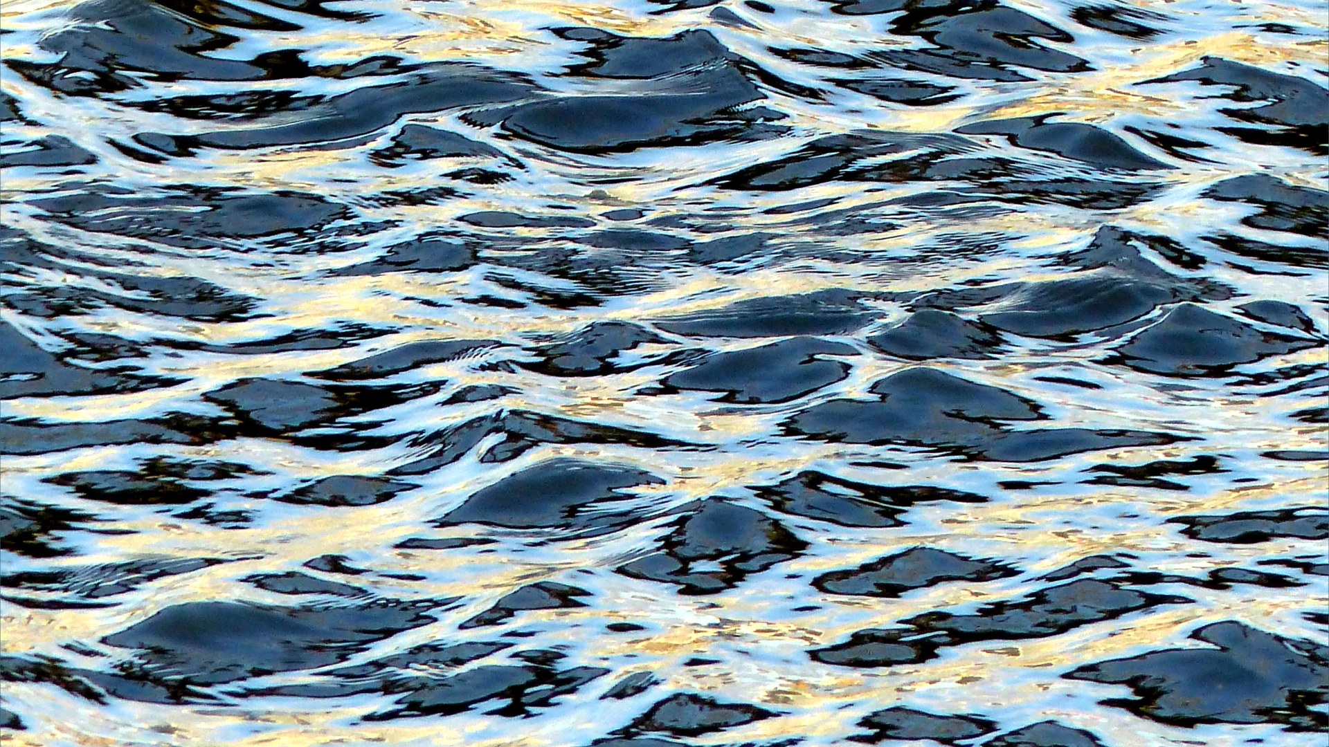 Reflected light on water in a deep flowing river