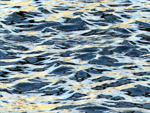Reflected light on water in a deep flowing river