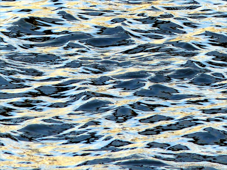 Reflected light on water in a deep flowing river