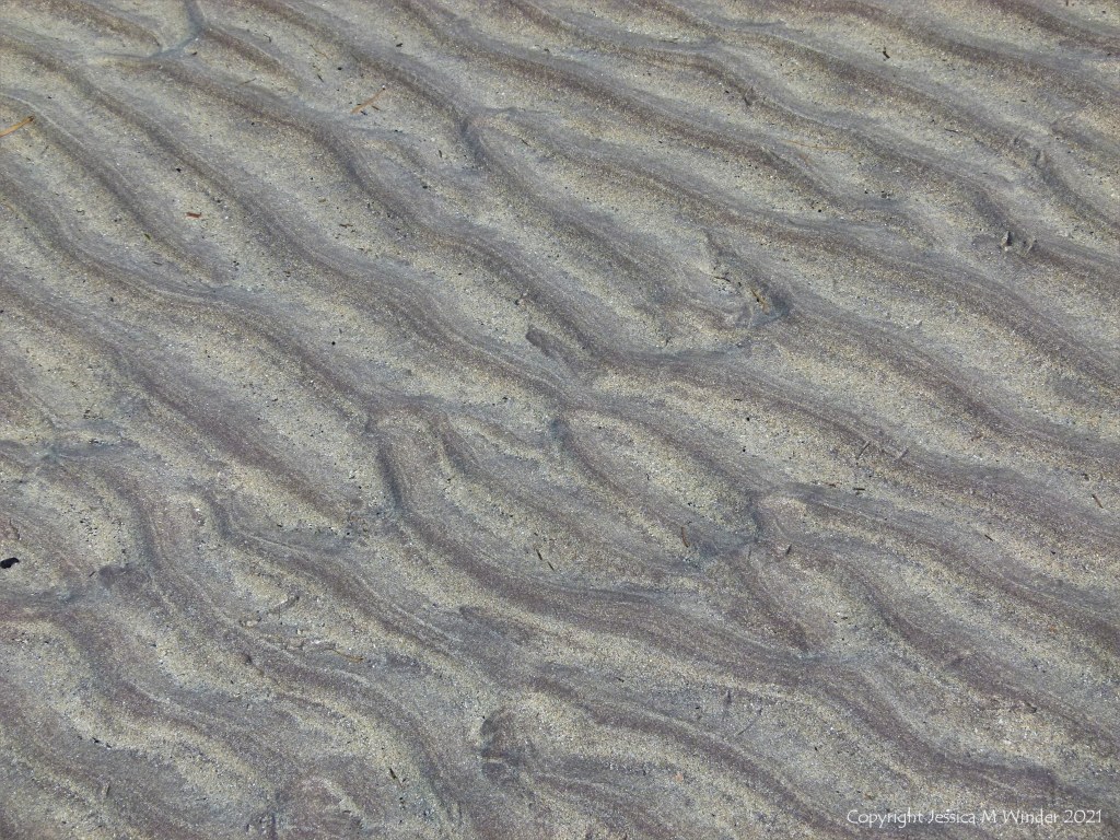 Natural sand ripples left by the tide on the beach