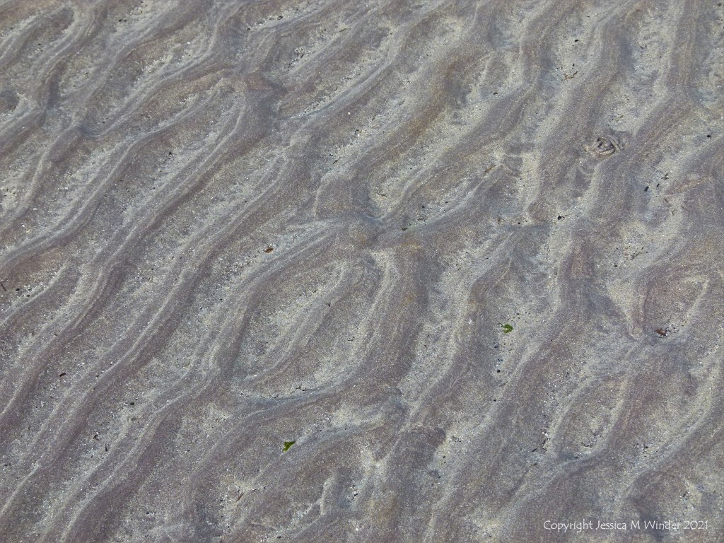 Natural sand ripples left by the tide on the beach
