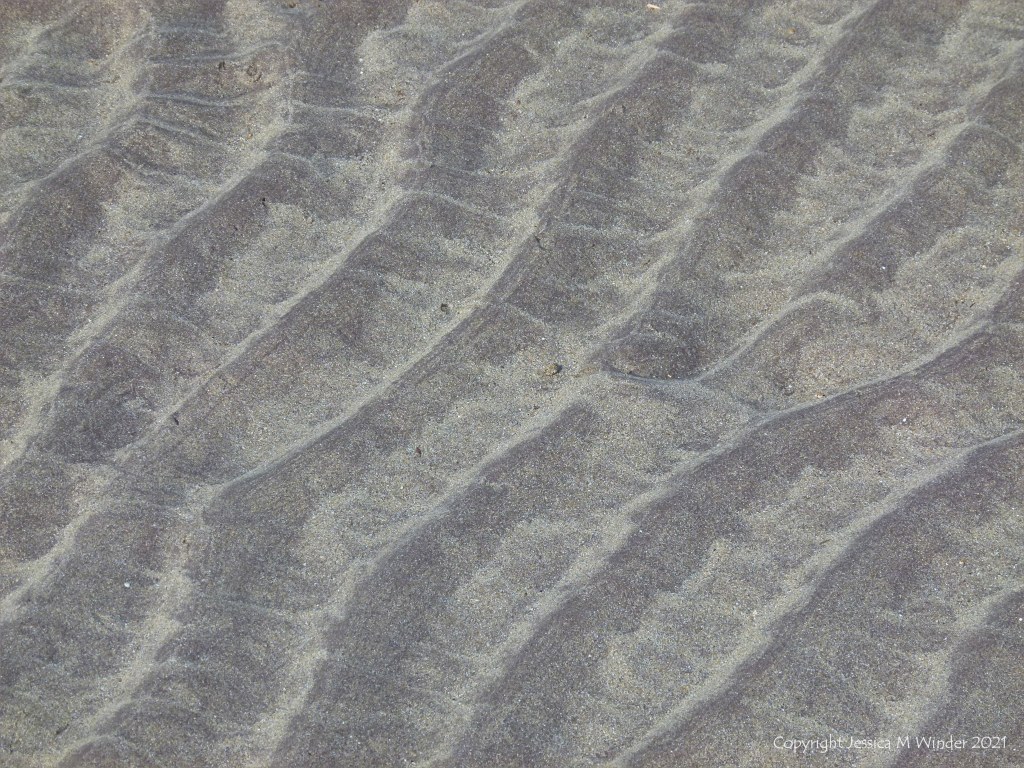 Natural sand ripples left by the tide on the beach
