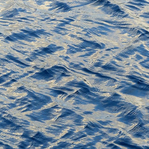 Detail of seawater pattern, water texture, and reflected light