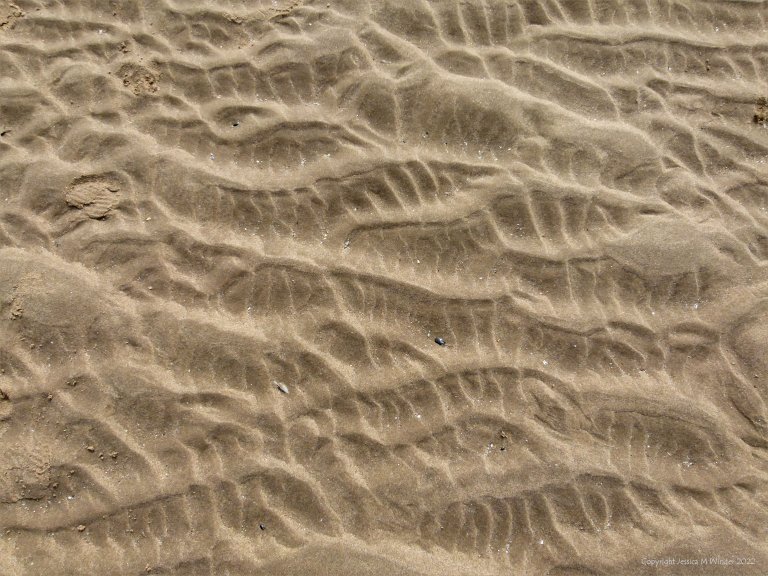 Natural abstract pattern on the surface of sand at the beach