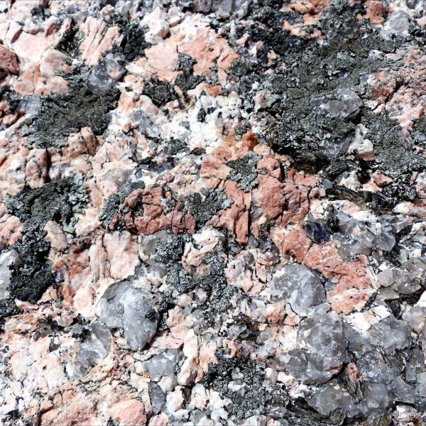 Close up of pink and grey granitic rock crystals