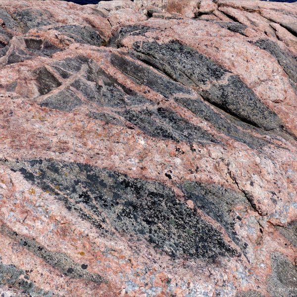 Natural patterns and textures in pink and grey granitic rock intrusions