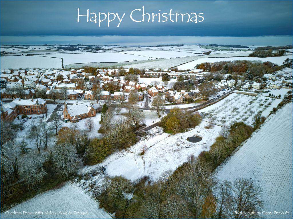 Snow covered landscape with fields, houses, winter trees, showing Community Orchard and